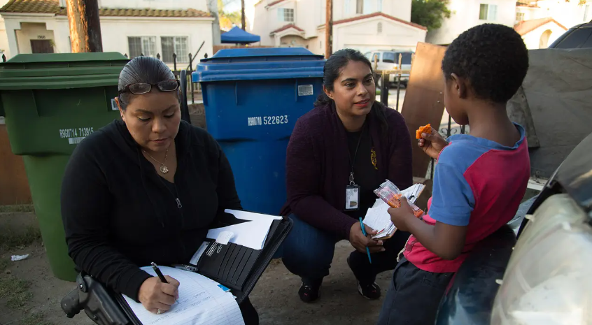 Community outreach workers gathering signatures